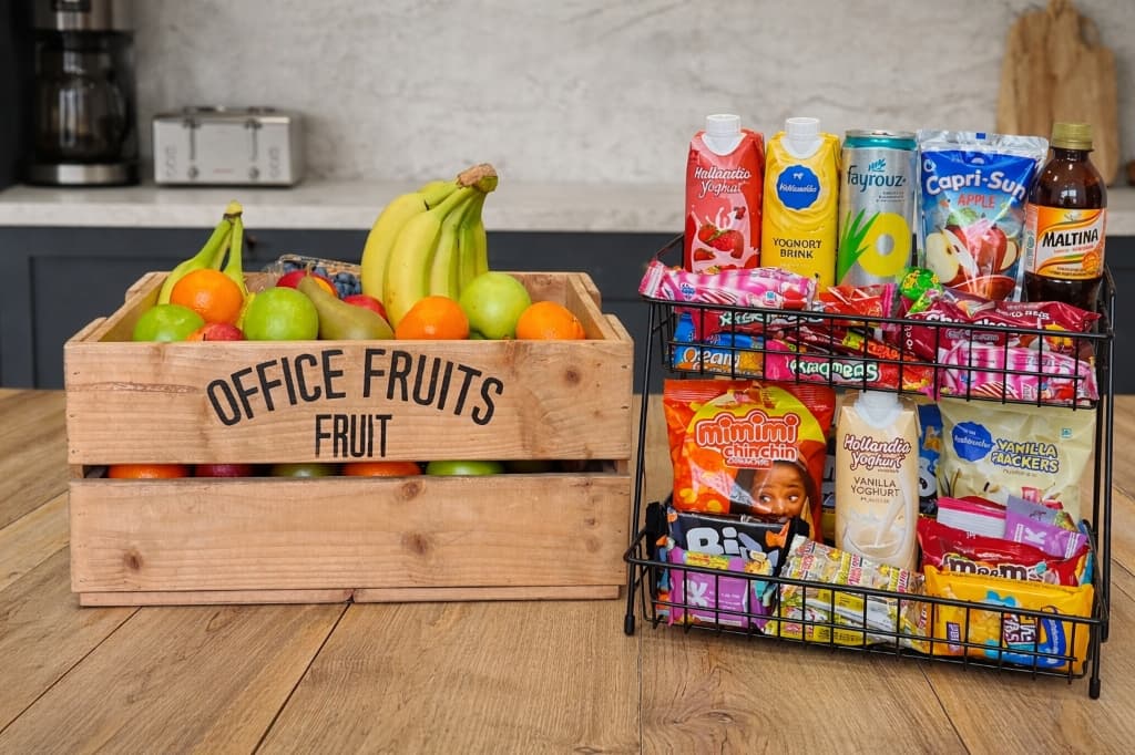 Wooden office fruit crate and stacked wire rack of pantry snacks and drinks
